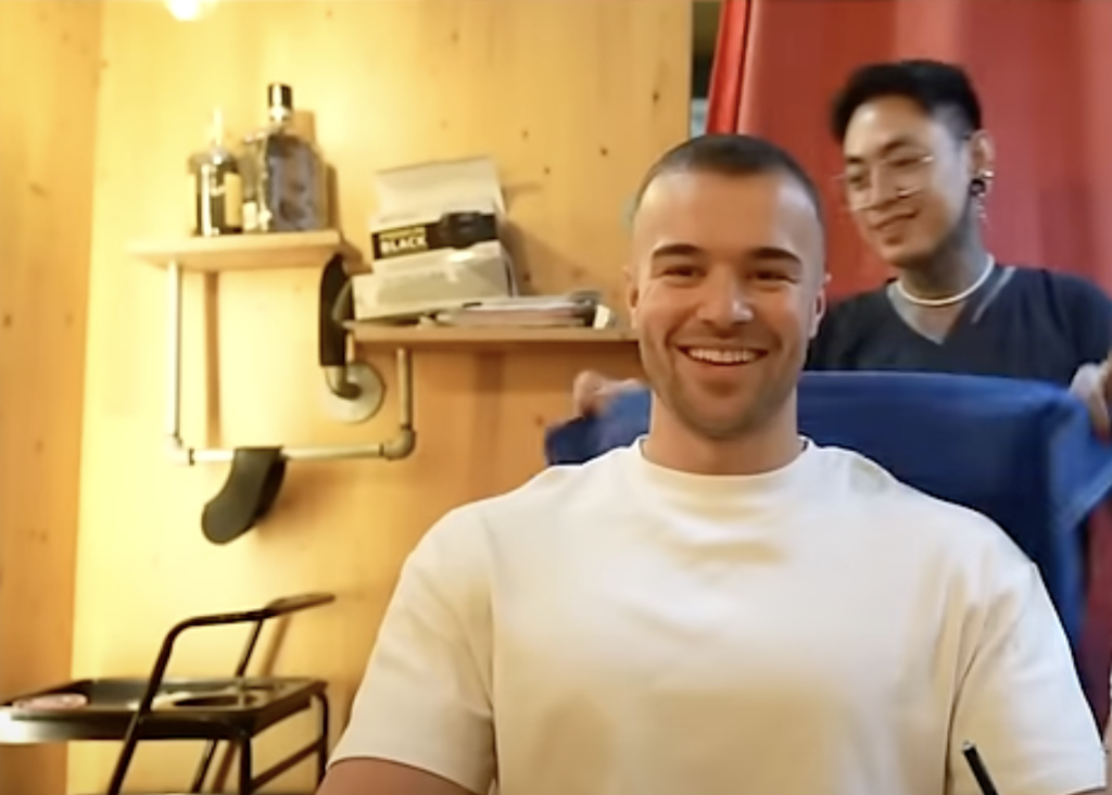Mo getting a haircut six months after his hair transplant, showcasing hair growth and thickness.