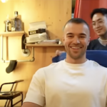 Mo getting a haircut six months after his hair transplant, showcasing hair growth and thickness.