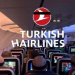 An airplane cabin scene where multiple passengers wearing head bandages—likely from recent hair transplant procedures—are seated, playfully referencing “Turkish Hairlines.”